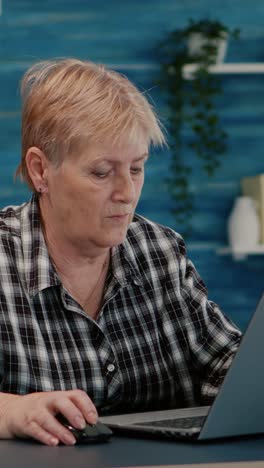 vertical video: senior mature older woman watching business training