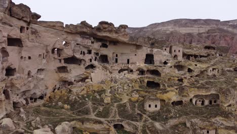 Cappadocia,-a-semi-arid-region-in-central-Turkey,-is-known-for-its-distinctive-fairy-chimneys-tall,-cone-shaped-rock-formations-clustered-in-Monks-Valley,-Göreme-and-elsewhere