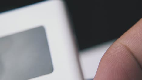 man holds power bank with screen extreme close view