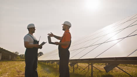 solar panel technicians discussing maintenance