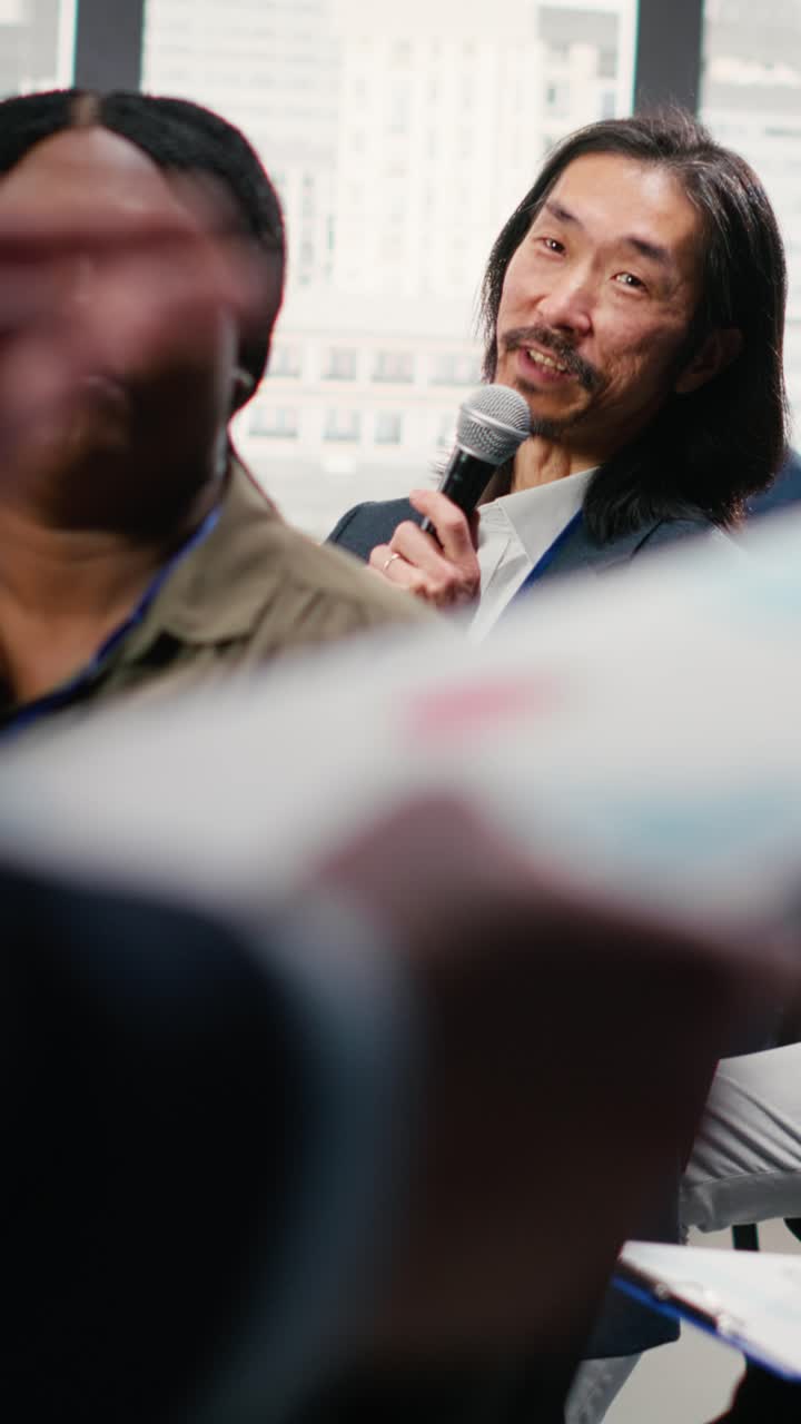 Vertical Video Asian businessman in audience interacting with presenter