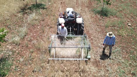 farmers harvesting with tractor