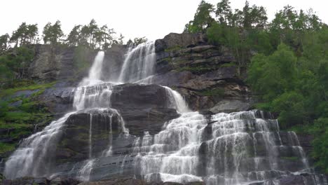 Tvindefossen-Norway---Smooth-and-close-tilt-up-reveal-of-majestic-waterfall