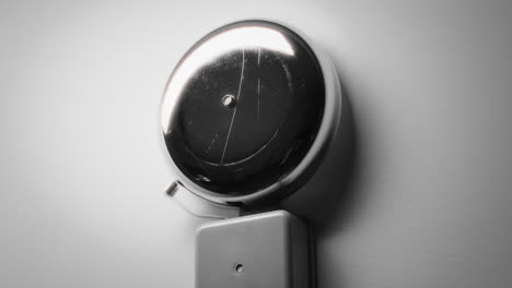 grey color bell on the wall ringing for school start lessons