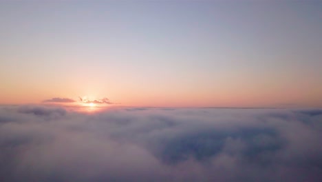 aerial dreamy and scenic view at sunrise low above the clouds