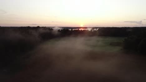 flight above sunset fog in golden hour after rain