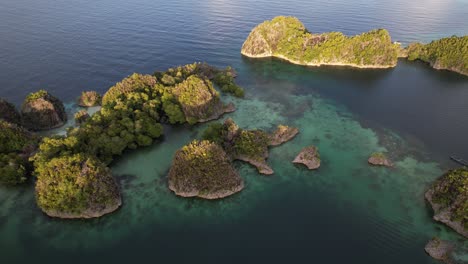 flying above the small islands in piaynemo raja ampat indonesia