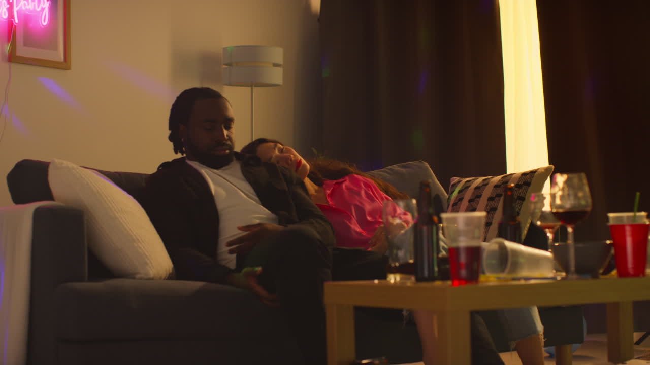 Couple Waking Up On Sofa After Drinking Alcohol At House Party Suffering With Hangover 5