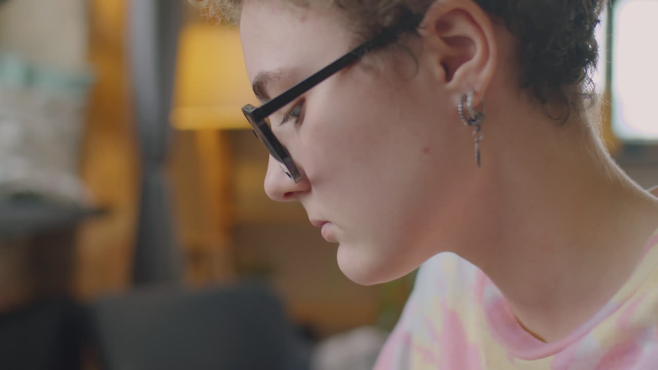 Girl with Prosthetic Arm Painting Picture on Paper