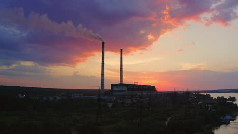 power plant by sunset in the landscape with lake. timelapse video.