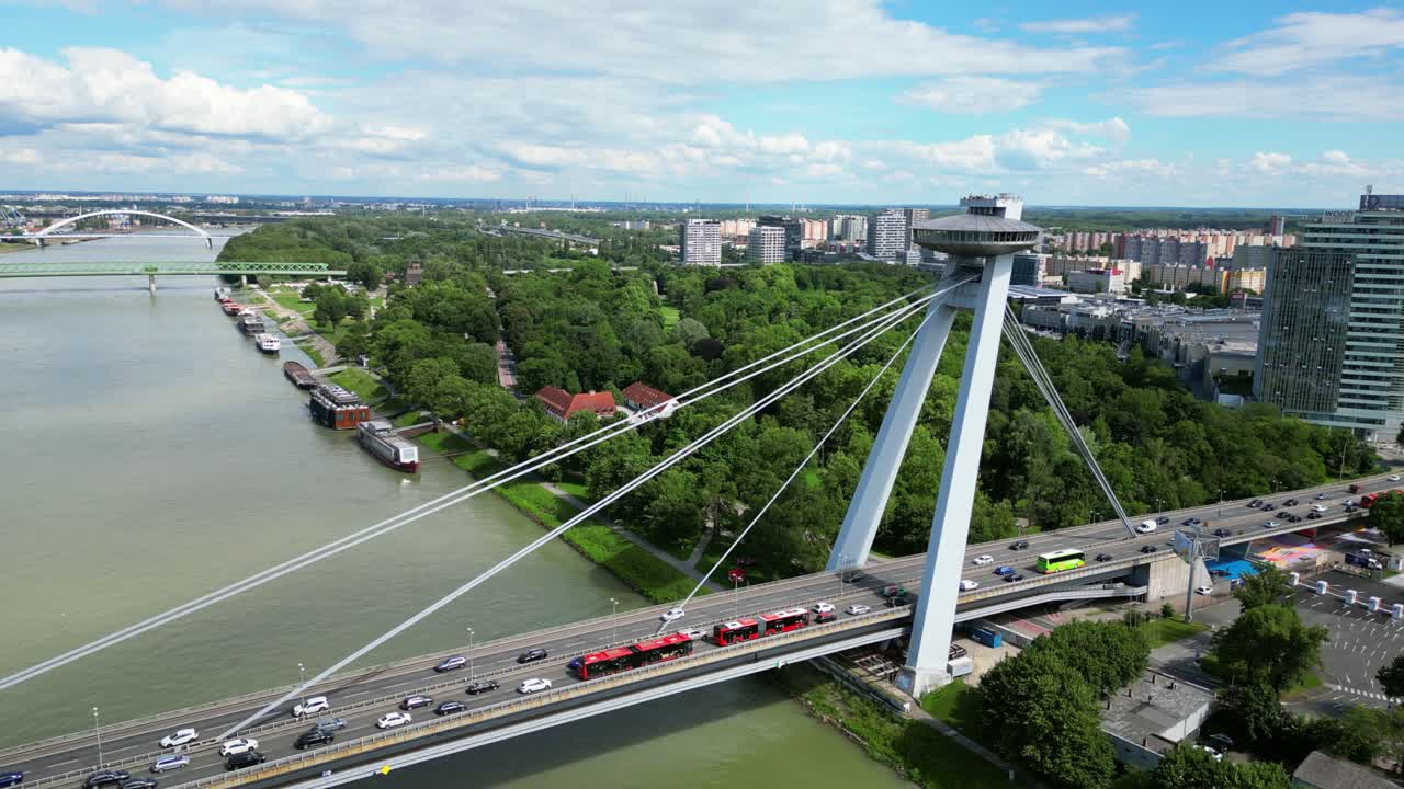 Traffic At SNP Bridge Over Danube River In Bratislava, Slovakia. - aerial pullback shot