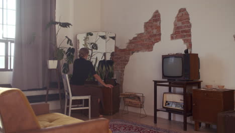 woman looking at herself in a mirror in a stylish retro apartment