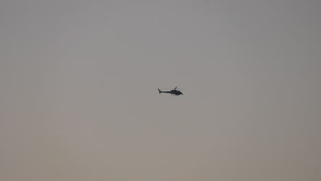 helicóptero volando por el cielo al amanecer