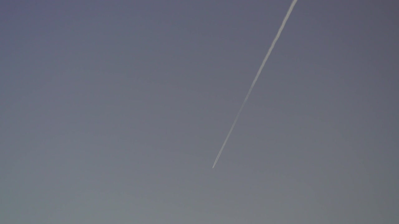 Jet making a contrail in the blue sky