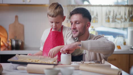 father and son cooking in the kitchen