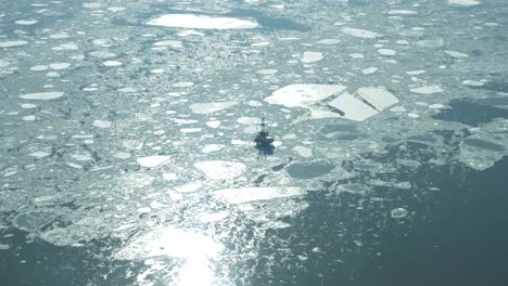 Flight-over-the-icy-waters-Cook-Inlet-in-Alaska-during-winter-with-vast-expanses-of-snow-covered-forests,-rivers,-valleys,-and-mountain-peaks-of-the-Chugach-Mountain-Range