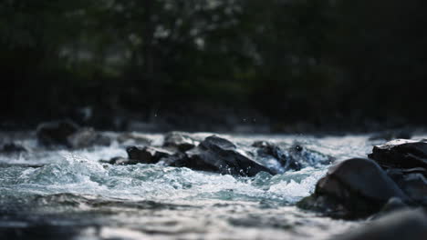 Wild-mountain-river-flowing-through-stone-boulders