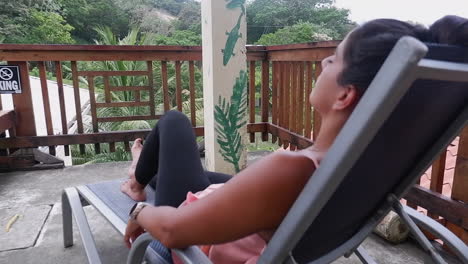 Female-Hispanic-traveler-relaxes,-naps-on-lounge-chair-on-jungle-deck