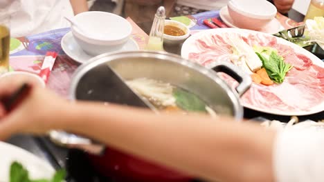 cooking and sharing hotpot meal in bangkok