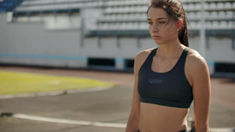 slow motion: girl athlete waits for start of race in 400 meters. girl athlete waits for start of race in 100 meters during. running at the stadium from the pads on the treadmill