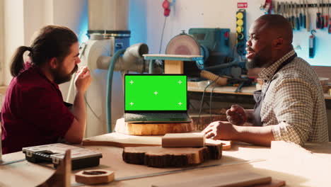 joyous cabinetmaker look over blueprints schematics on isolated screen laptop
