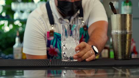 latin mexican mixologist prepare exotic cocktail drink at beach restaurant tequila mezcal mojito gin refresher fresh with cucumber garnish serving from shaker