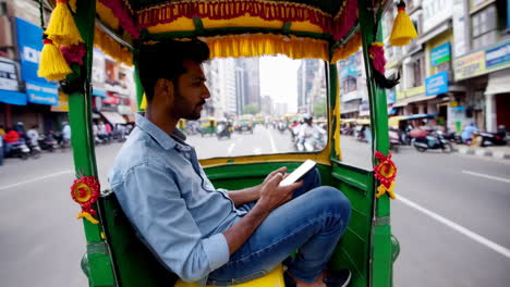 man using a smartphone while traveling in an auto-rickshaw on a city street