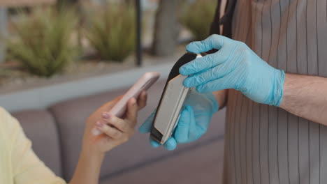 customer paying for coffee with smartphone