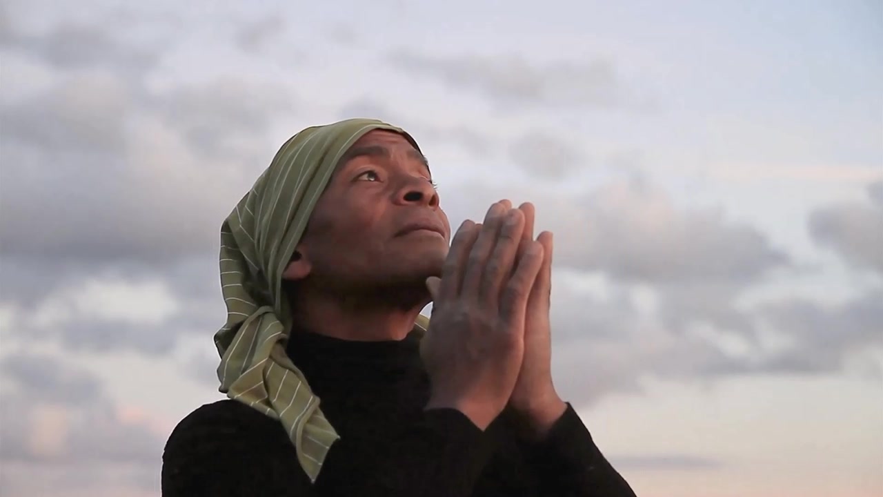 black man praying to god with arms outstretched looking up to the sky stock footage