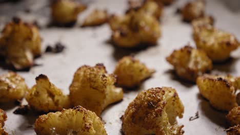 Close-up-View-of-Roasted-Cauliflower-on-Baking-Sheet---Tilt-Shot