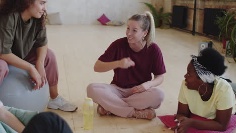 young people chatting and laughing after dance class