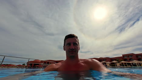 young adult male in a cool, refreshing swimming pool - selfie travel destination shot