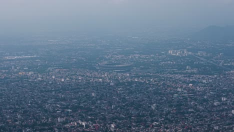 drone view of mexico city's estadio azteca, encircled by extensive housing zones
