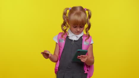 Teenage-girl-kid-in-school-uniform-using-credit-bank-card-and-smartphone,-purchases-online-shopping