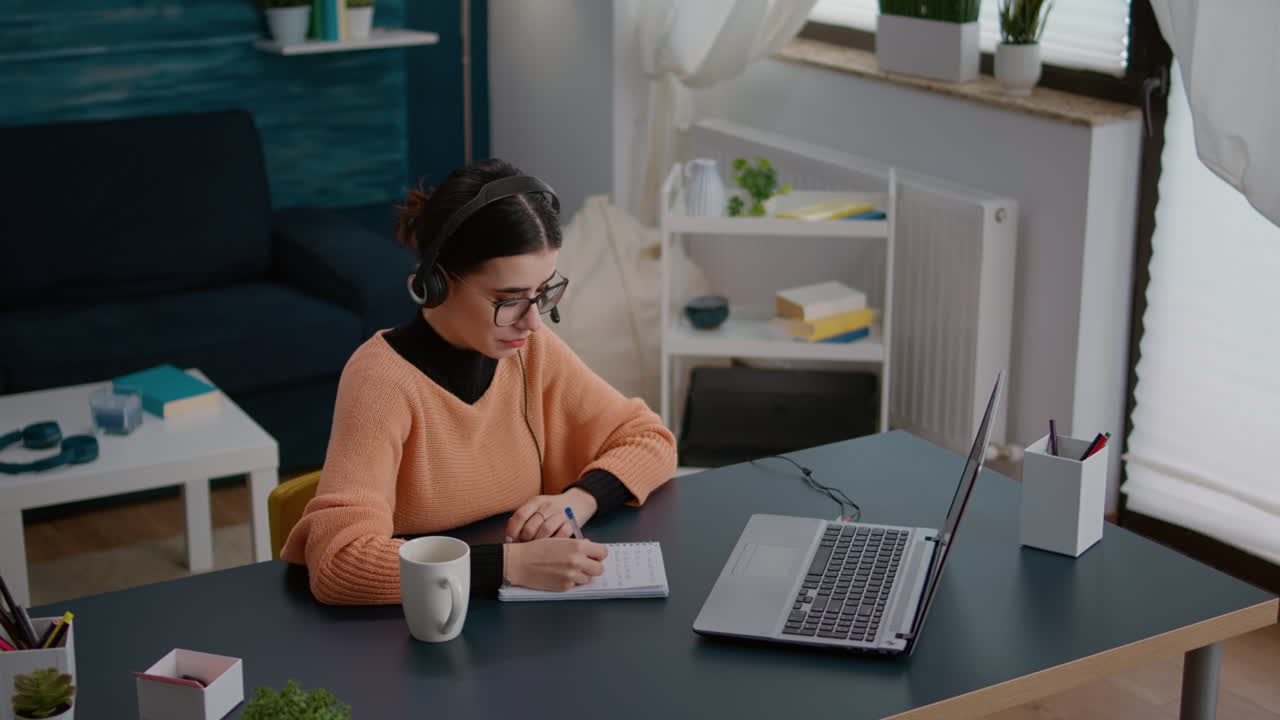 University student listening to online school class on laptop