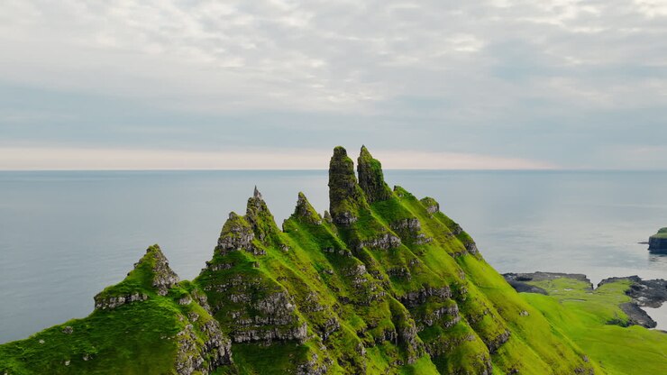 Dramatic green sea cliffs and sea stacks along the coast of the Faroe Islands