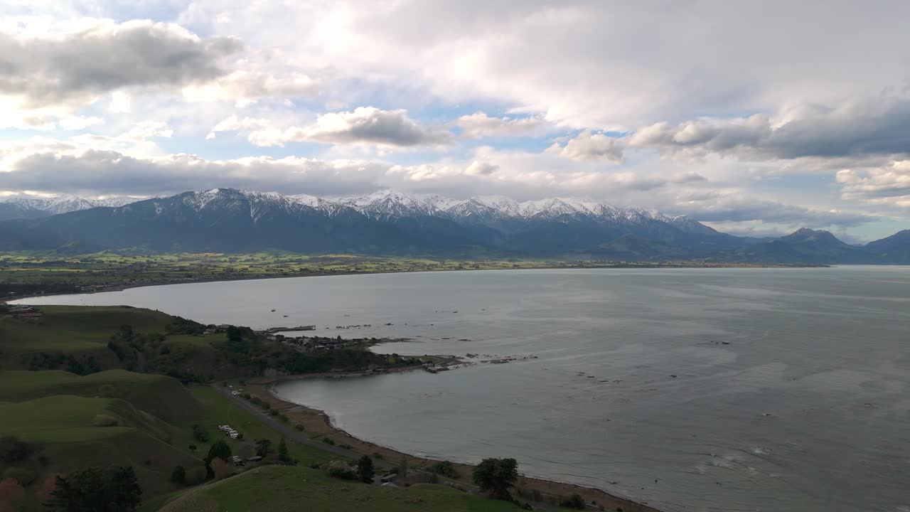 Panoramic view of the Kaikōura coastline with the Southern Alps in the background.