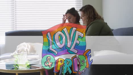 Animation-of-love-and-pride-over-lesbian-couple-doing-paperwork