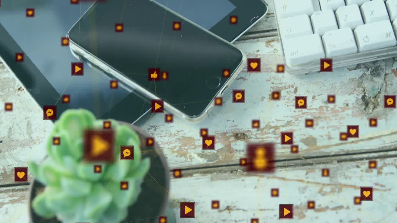 animación de una red de iconos digitales contra una tableta digital, un reloj inteligente y una planta en una superficie de madera.