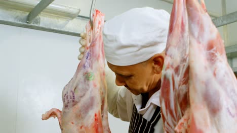 butcher hanging meat in butchers shop 4k