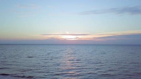 beautiful aerial establishing view of baltic sea coast on a sunny evening, sunset, golden hour, beach with white sand, coastal erosion, climate changes, wide angle ascending drone shot moving forward