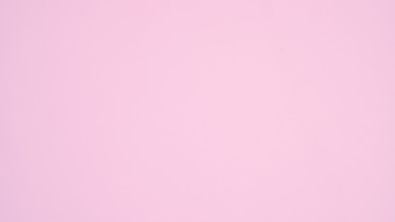 Red ribbon make Valentine's day heart on pastel pink theme. Stop motion