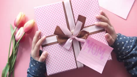 child giving a gift to mom for mother's day