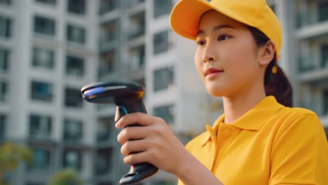 a young female worker in a bright yellow outfit using a handheld scanner in an urban environment, representing technology, efficiency, and modern service
