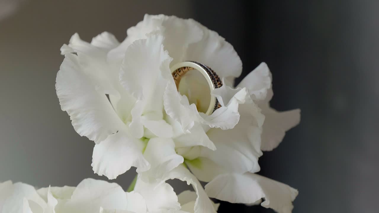 Elegant Wedding Ring Nestled in a White Lisianthus Flower