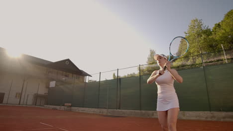 tennis game on sunny day at tennis court young sportive woman playing professional tennis.