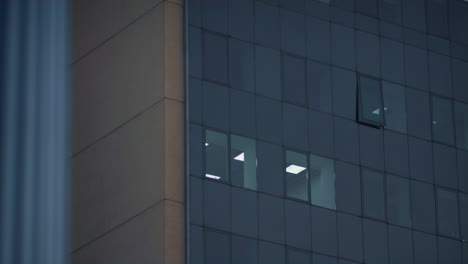 drone shot office windows at downtown district. business company working late