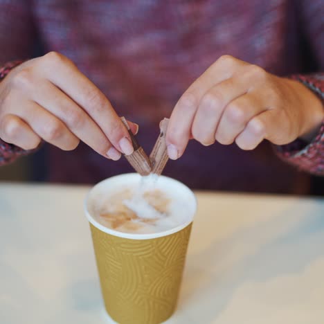 woman adding sugar to her coffee in a fast food restaurant. unhealthy eating and drinks concept