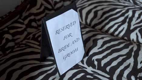 reserved for bride and groom sign on couch