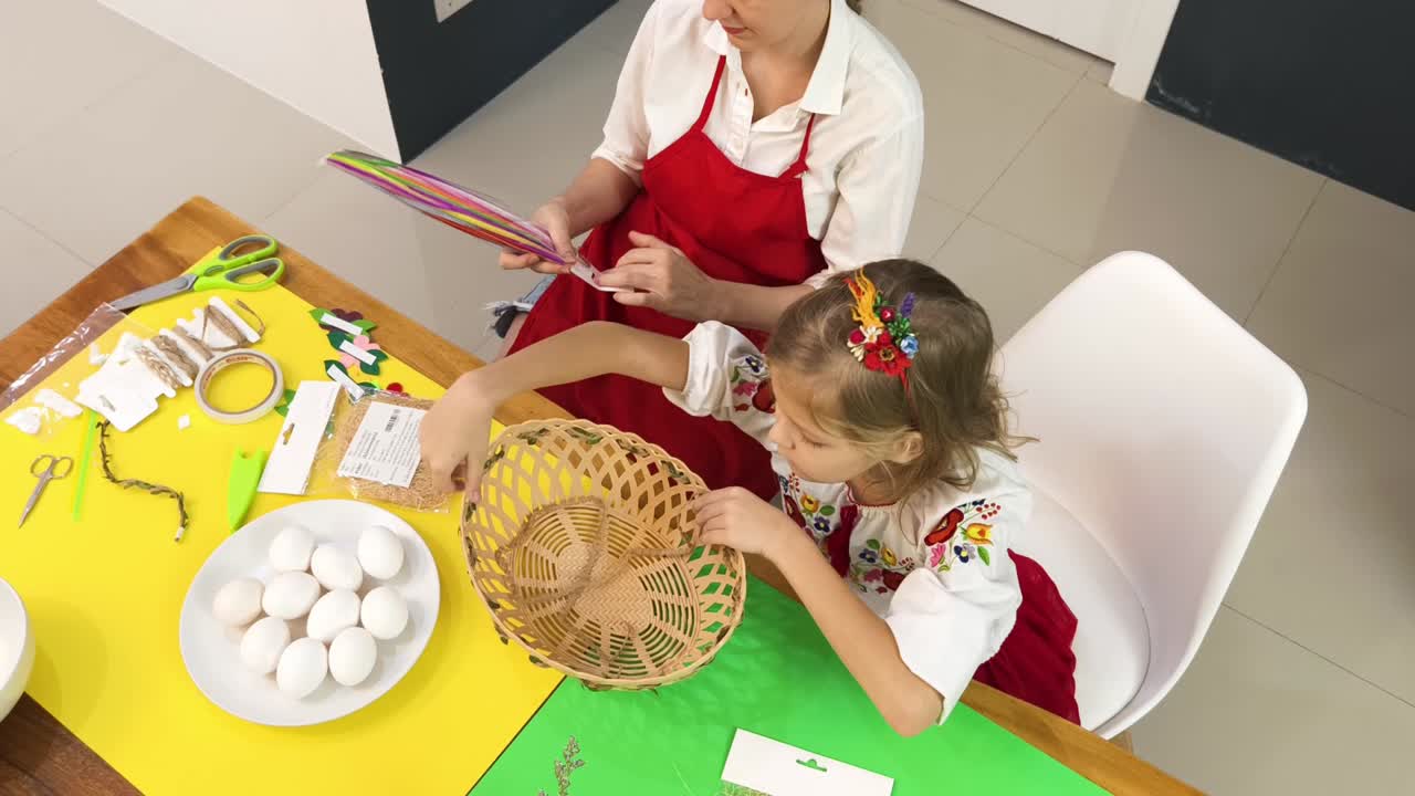 어머니 와 딸 이 부활절 바구니 를 만들고 있다